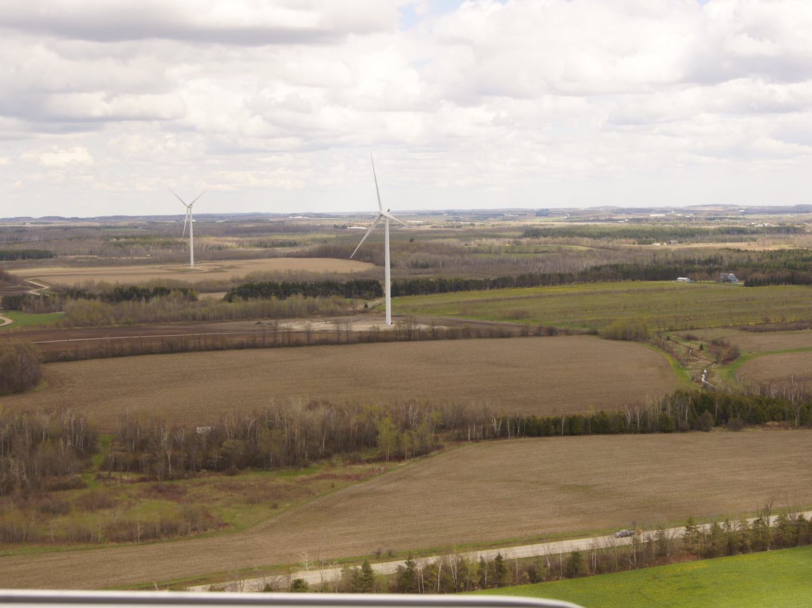 An aerial view of a wind turbine in a field